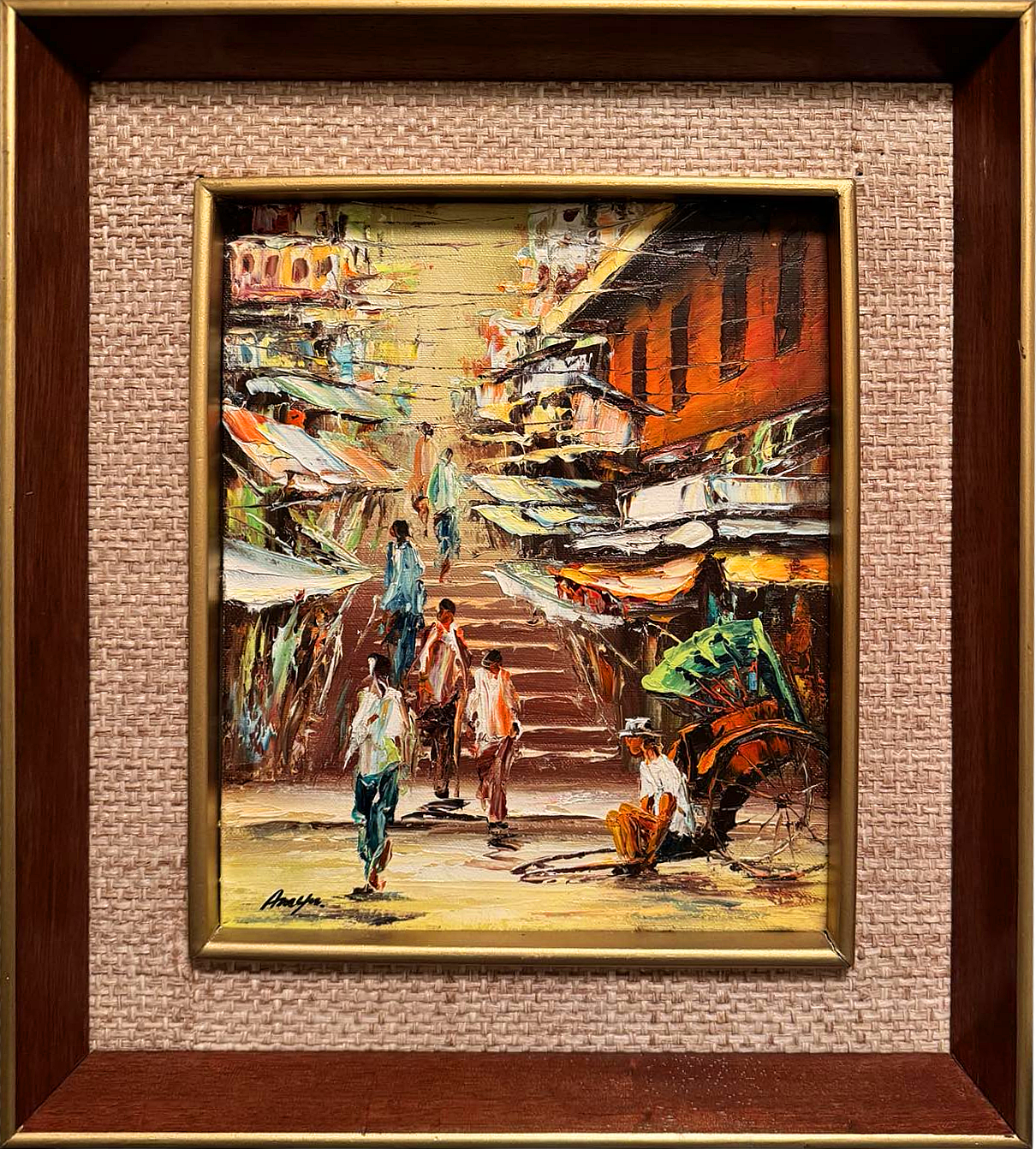 This original painting captures the lively energy of a bustling street market, where vendors and customers converge under the soft warmth of the sun. The artist skillfully blends tones of ochre, orange, and green to create an immersive street scene that transports the viewer into the heart of this dynamic marketplace. 