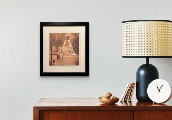 A sepia-toned depiction of a rainy evening by the Eiffel Tower, capturing the romance and timeless allure of Paris under the glow of street lamps. This timeless scene beautifully evokes the serenity and magic of a quiet Paris night, inviting the viewer to savor the elegance of the City of Light.