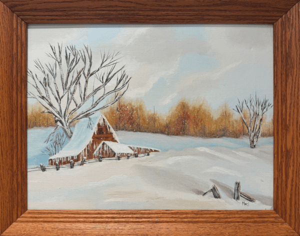 The quiet beauty of a snow-covered barn nestled in a calm winter landscape while it stands in contrast to the soft white surroundings, framed by the gentle colors of the horizon.