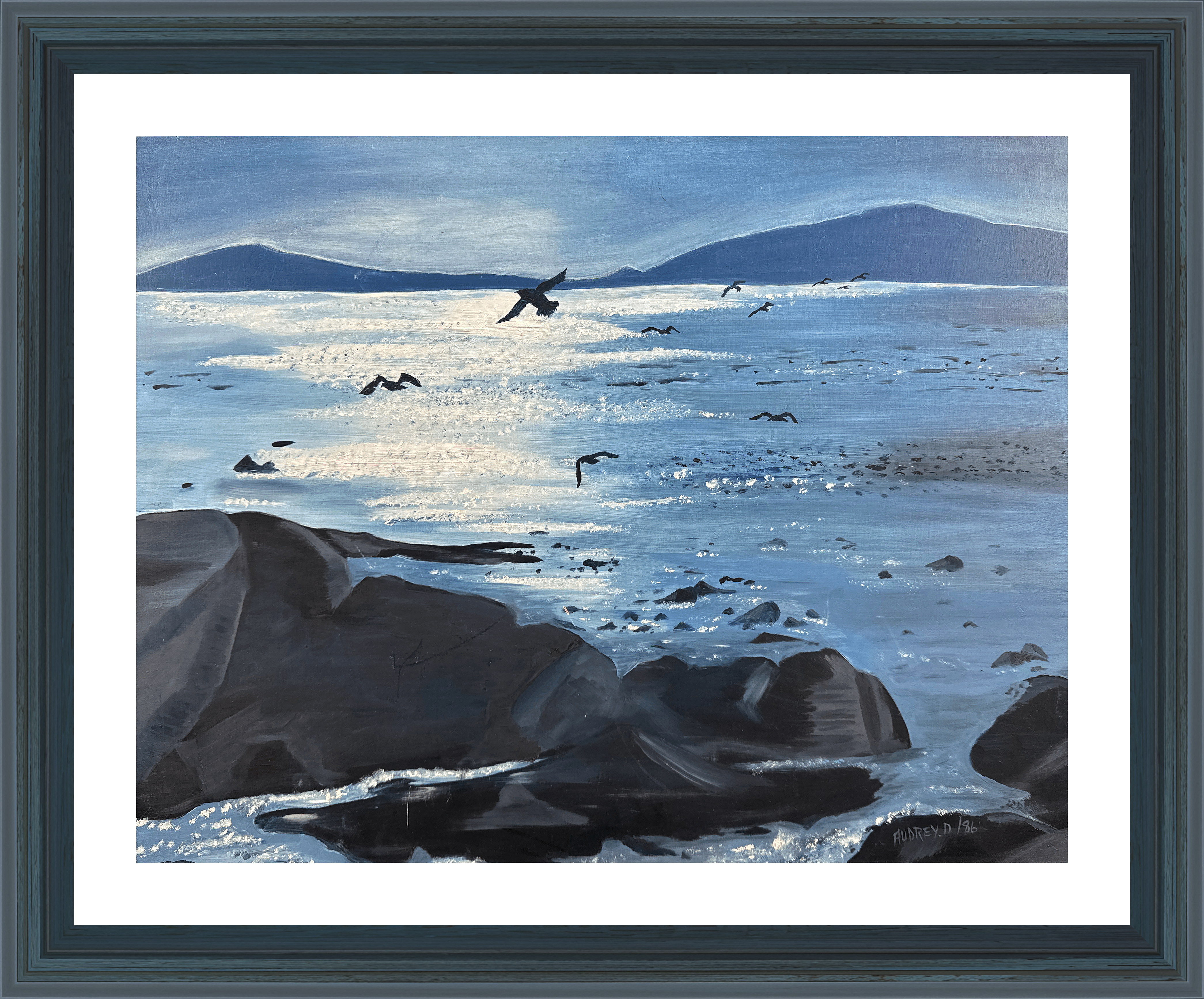 A tranquil seascape painted in 1986. The artwork captures the gentle movement of birds gliding over a calm ocean, framed by distant mountains and the soft light of the setting sun transporting viewers to a quiet shoreline - creating a sense of peace.