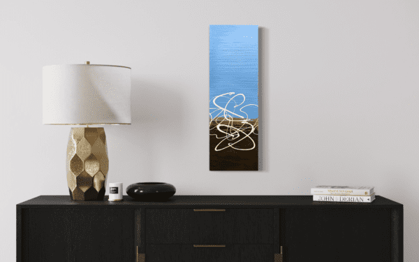 Soft sky blue blends into rich earth tones in this abstract painting, where white lines trace a path of quiet exploration. A sense of gentle, unhurried movement makes this piece contemplative and serene.